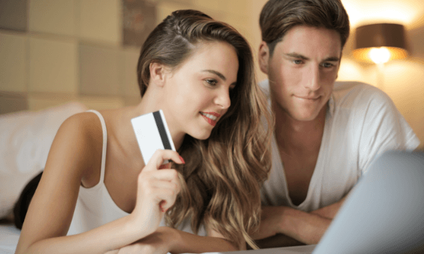 cheerful-couple-making-online-purchases-at-home-3756345